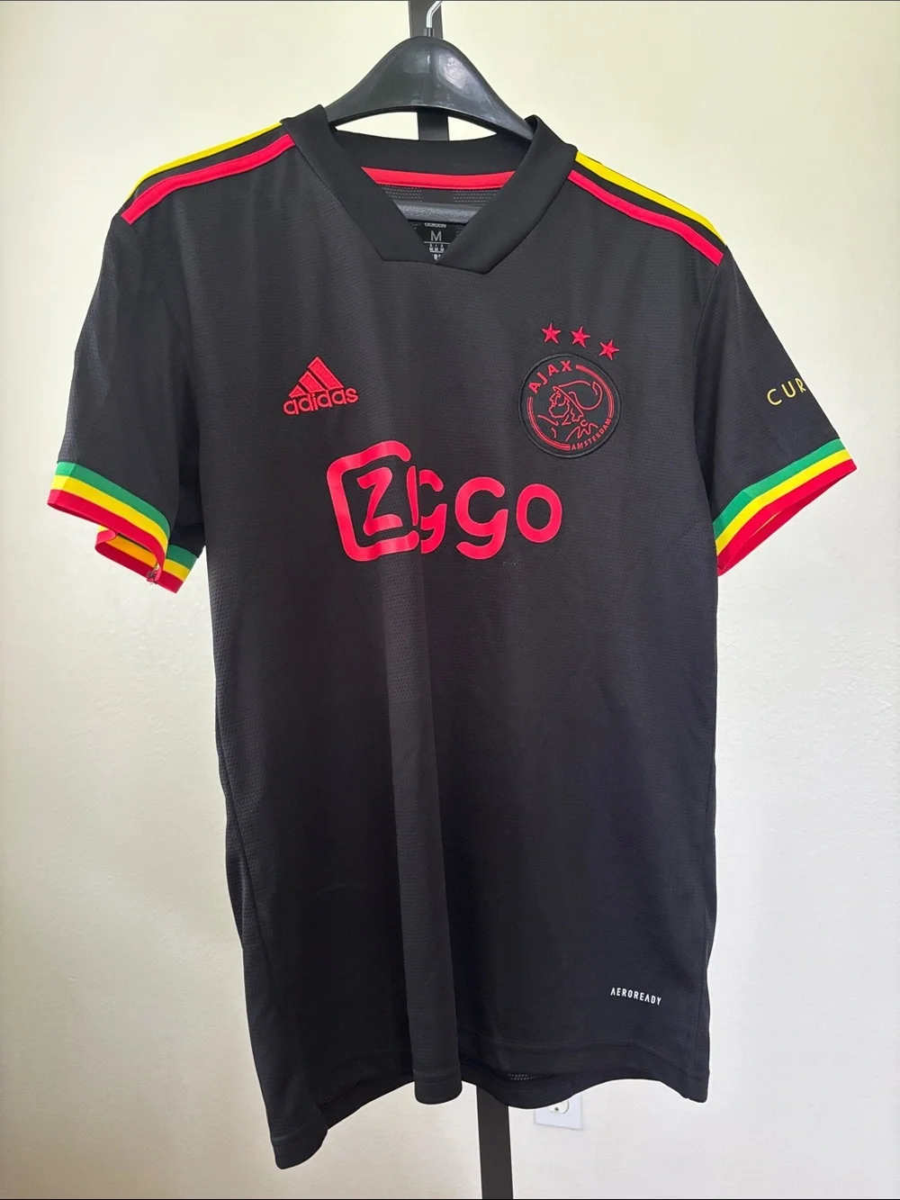 adidas Kids Black Ajax Jersey with Red Logos and Rasta Trim